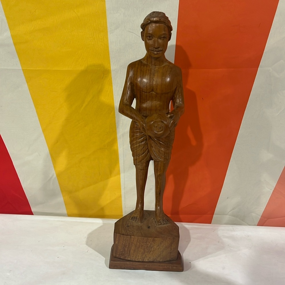 Vintage mid-century wooden statue of man with cloth.